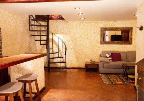 a living room with a staircase and a couch at Hotel Casa Pereyra in Oaxaca City
