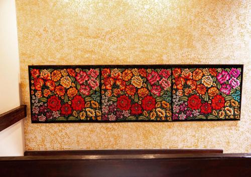 a painting of flowers hanging on a wall at Hotel Casa Pereyra in Oaxaca City