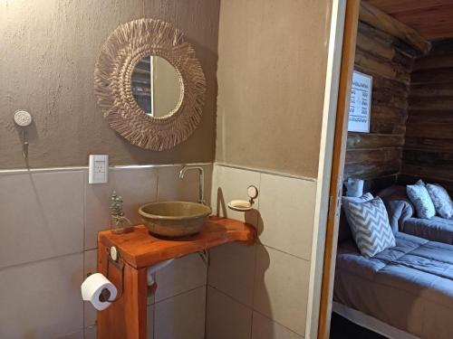 a bathroom with a bowl sink and a mirror at Sommerwind Cabañas in La Estancia
