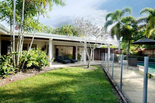 a house with a patio and a swimming pool at Alani - Absolute Beachfront - Sleeps up to 10 in Mission Beach