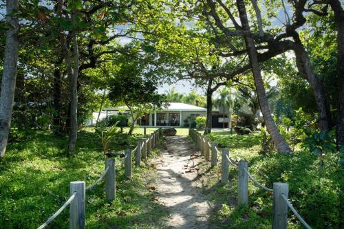 a path in front of a house with a fence at Alani - Absolute Beachfront - Sleeps up to 10 in Mission Beach