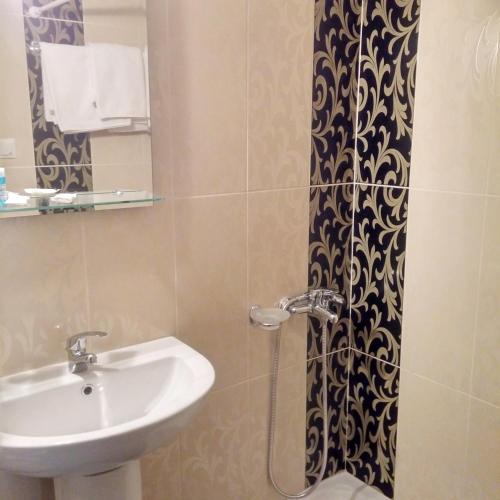 a bathroom with a sink and a shower at Castella Beach in Alissos