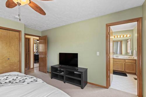 a bedroom with a bed and a flat screen tv at Hot tub! Sleeps 8-11Upscale Area in Spokane