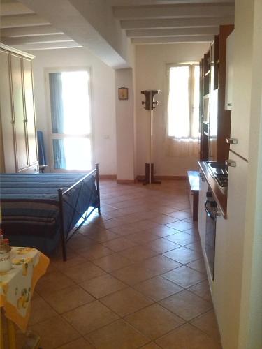 a living room with a bed and a table at Appartamenti Claudia Rio in Rio Marina