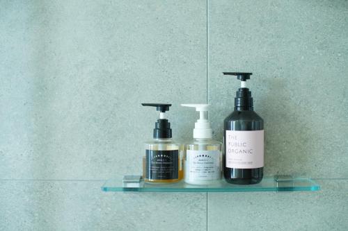a shelf with two bottles ofodorizers on a wall at Villacation the Loose in Minamiawaji