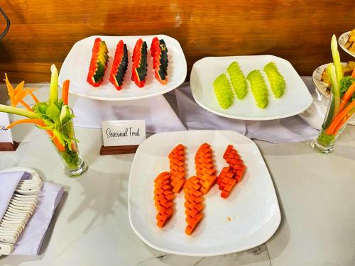 three plates of carrots and vegetables on a table at LOI LOUNG HOTEL in Taunggyi