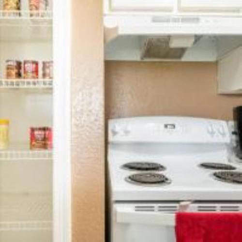 a white stove in a kitchen next to a refrigerator at Lovely 2- bedroom apartment with nice amenities in Houston