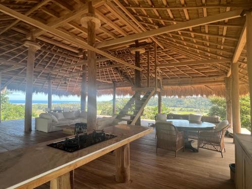 an open living room with a fireplace in a house at Sumba Farm House in Sumba