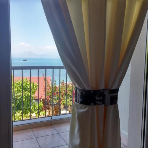 a room with a window with a view of the ocean at Castella Beach in Alissos