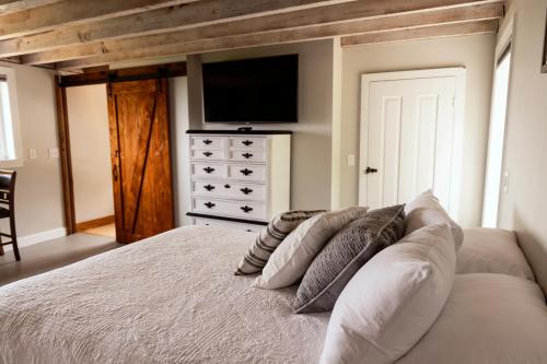 a bedroom with a bed with pillows and a tv at Valley View Cabin in Morris