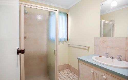 a bathroom with a shower and a sink at Comfortable Elevated Holiday Home in Encounter Bay