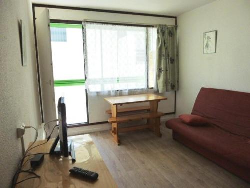 un salon avec un canapé et une table dans l'établissement Studio cosy pour 4 pers. à deux pas des pistes avec kitchenette et loggia - Arette - FR-1-602-113, à Arette
