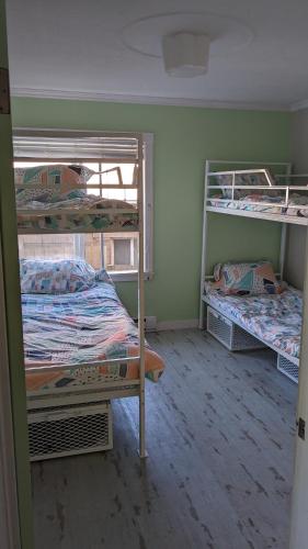 a room with three bunk beds in it at Laughing Llama in Vernon