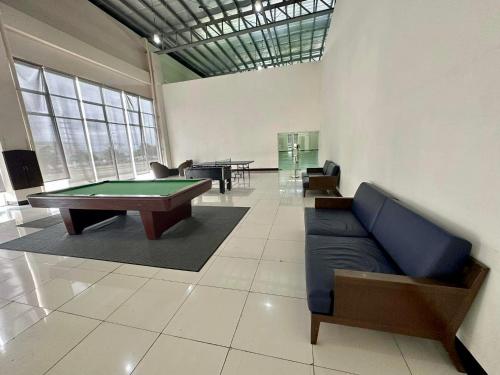 Cette chambre dispose d'un billard et d'un canapé. dans l'établissement Munting Tahanan sa Tagaytay, à Tagaytay