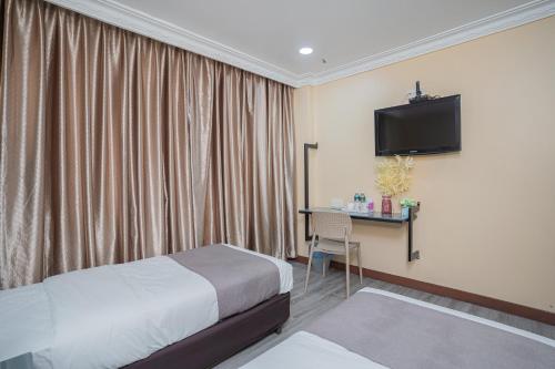 מיטה או מיטות בחדר ב-Hotel 28 Titiwangsa