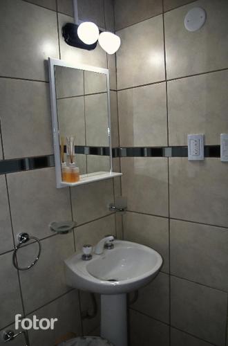 a bathroom with a sink and a mirror at Hospedaje Emma&Anna Dpto 1 in Ushuaia