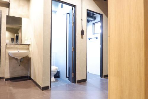 a bathroom with a toilet and a sink at bangkok bed place in Bangkok