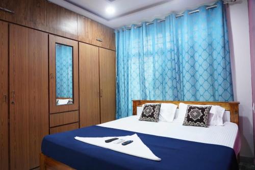 a bedroom with a bed with a blue curtain at Sea side guest house vizag in Visakhapatnam