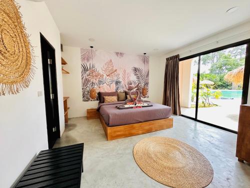 a living room with a bed and a table at Zibá Home Suites in Lamai