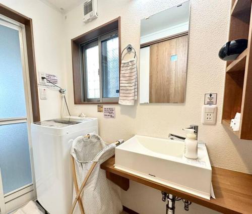 a bathroom with a sink and a washing machine at KOTORI HOUSE in Kyoto