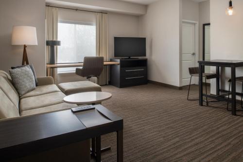 a living room with a couch and a tv at Residence Inn by Marriott Portland Vancouver in Vancouver