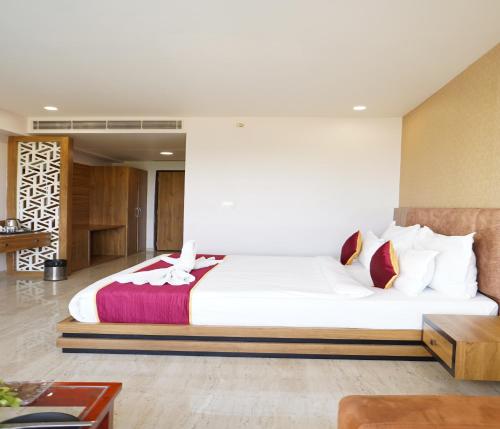 a bedroom with a large white bed in a room at Bamboo Saa Mulberry Resort Pushkar in Pushkar