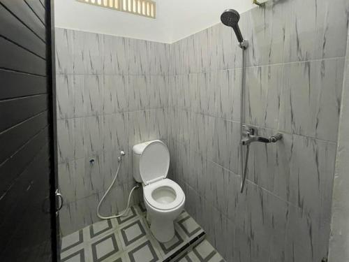 La salle de bains est pourvue d'une douche et de toilettes. dans l'établissement RedDoorz @ Balige Toba Samosir, à Balige