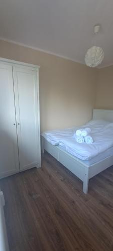a small bedroom with a bed and a cabinet at Apartament Barcelona in Kłodzko