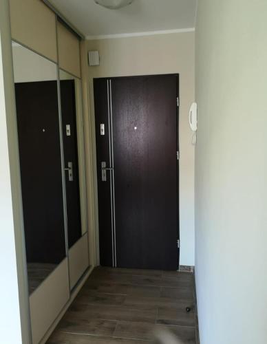 a hallway with two sliding doors in a building at Apartament Barcelona in Kłodzko