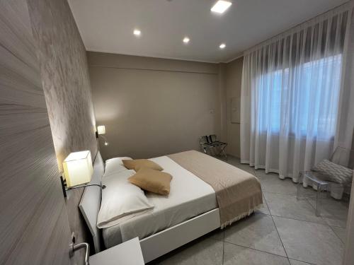a bedroom with a bed and a large window at B&B Lamezia Central Airport in SantʼEufemia Lamezia