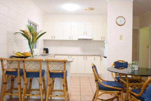 a kitchen with a table and chairs and a counter at Beachfront on Mission - Absolute Beachfront in Mission Beach