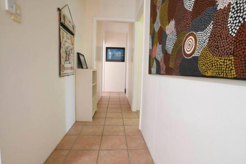 a hallway with a tile floor and a painting on the wall at Beachfront on Mission - Absolute Beachfront in Mission Beach