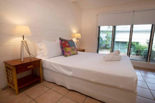a bedroom with a large bed with a stuffed animal on it at Beachfront on Mission - Absolute Beachfront in Mission Beach