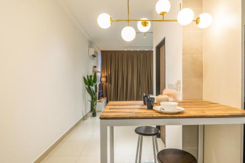a kitchen with a counter and stools in a room at Twin Tower Residence by Nest Home【5 mins walk to CIQ】 in Johor Bahru
