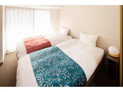 Postel nebo postele na pokoji v ubytování Coruscant Hotel Nagasakieki
