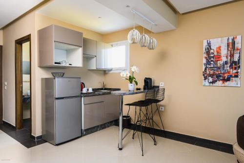 a kitchen with a refrigerator and a table in it at PLAYA DEL PACHA Suites Hotel in Marina Smir