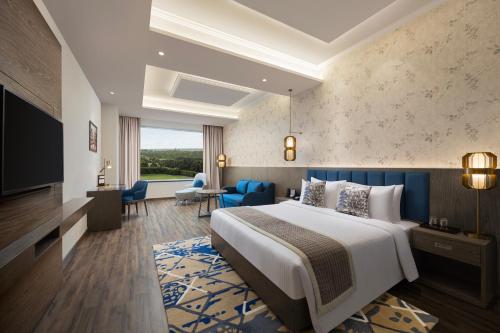 a hotel room with a bed and a television at Fortune Park, Hoshiarpur - Member ITC's Hotel Group in Hoshiārpur