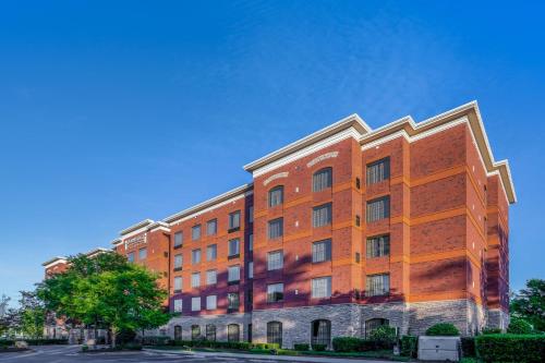 a large brick building on the side of a street at Staybridge Suites Wilmington East by IHG in Wilmington