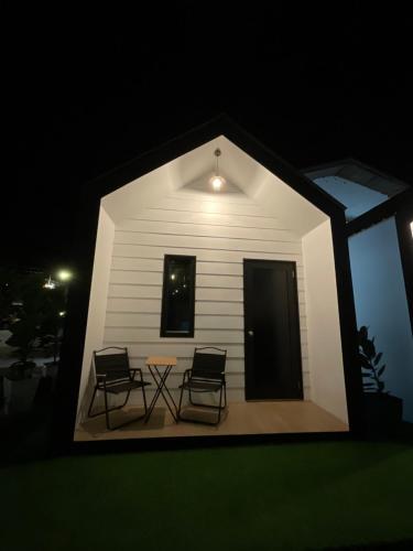 a house with two chairs and a table in the dark at The Sky Inn in Kuantan