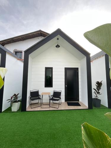 a rendering of a house with a patio and grass at The Sky Inn in Kuantan