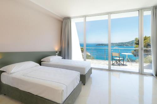 a hotel room with two beds and a view of the ocean at Cristallo Park Hotel in Portovenere