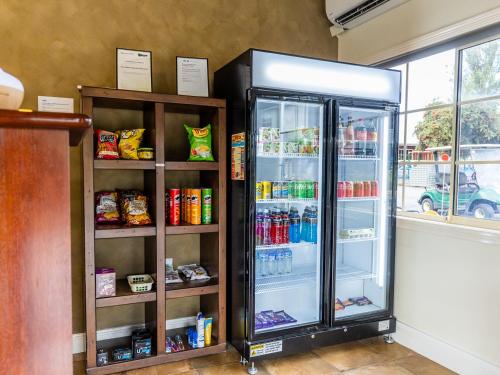 a refrigerator with its door open next to a window at NRMA Ballarat Holiday Park in Ballarat