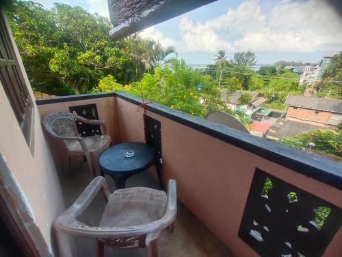 a balcony with a table and chairs and a view at Moon Light Rest in Galle