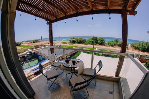 a view from the balcony of a house with a table and chairs at GW951 Gugel Waves Amazing Seaview Apartments in Nahariyya