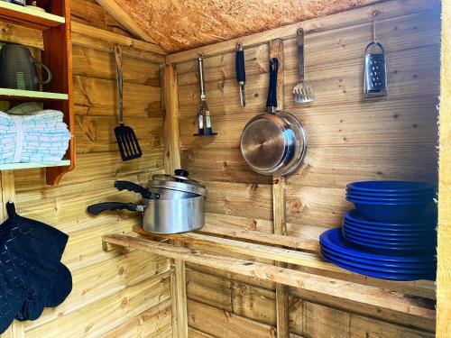 a kitchen with a pot and pans on a wall at Glyndwr Bell Tent in Builth Wells