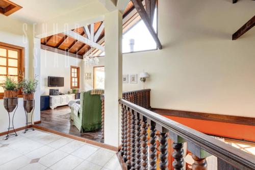 a staircase in a house with a living room at Mansão da Imperatriz: Vintage, Termas e Natureza in Santo Amaro da Imperatriz