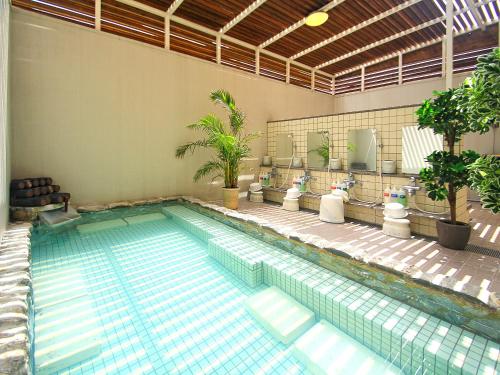 a large swimming pool in a building at Route Inn Grantia Ishigaki in Ishigaki Island