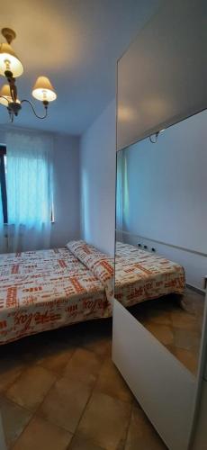 a bedroom with a bed and a mirror at Casa Mia Sirolo in Sirolo