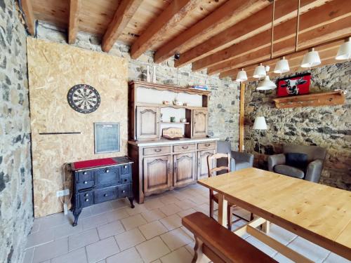 a dining room with a wooden table and a dining room gmaxwell gmaxwell gmaxwell at La Maison des Biscuits in Loubaresse