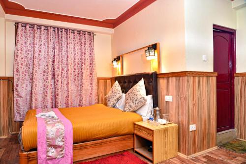 a hotel room with a bed and a table at Rufina Blue Pine in Lachen